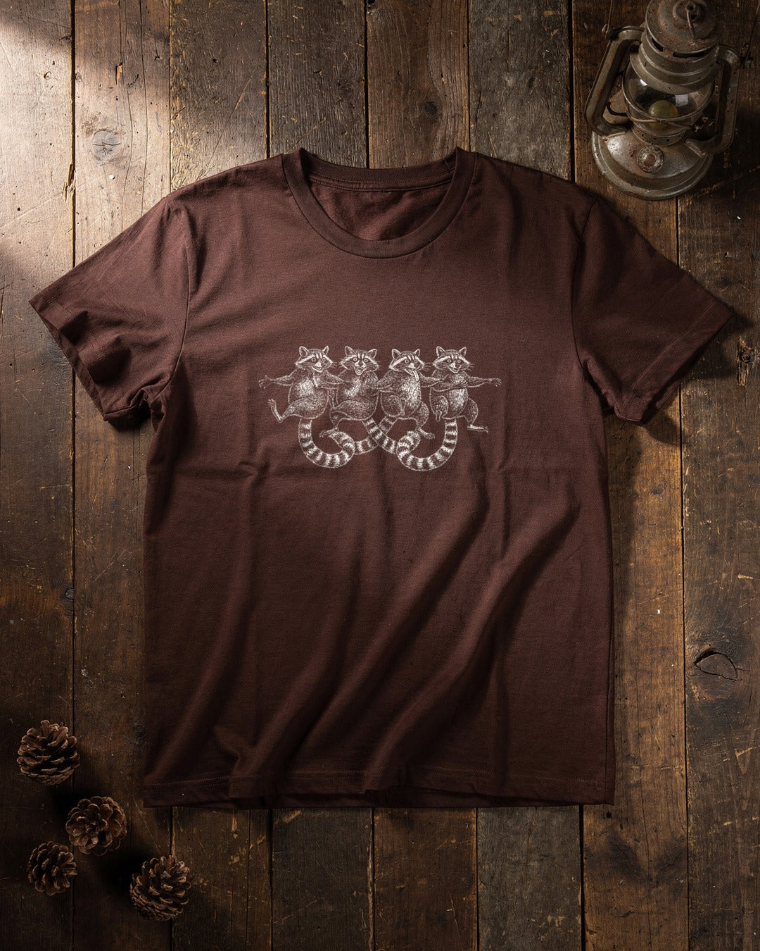 Dancing Raccoons T-shirt flat lay